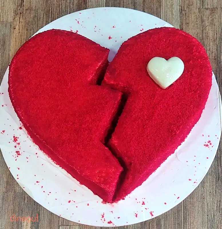 white heart cake with red flowing filling